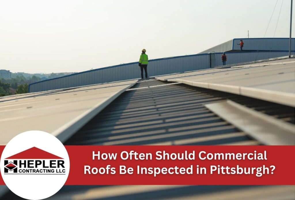Commercial roof inspection workers on industrial building in Pittsburgh with safety gear