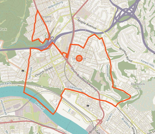 City map showing red outlined boundary with central orange marker point
